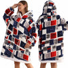 A woman models an oversized patchwork fleece hoodie featuring a mix of red, blue, and gray patterns.