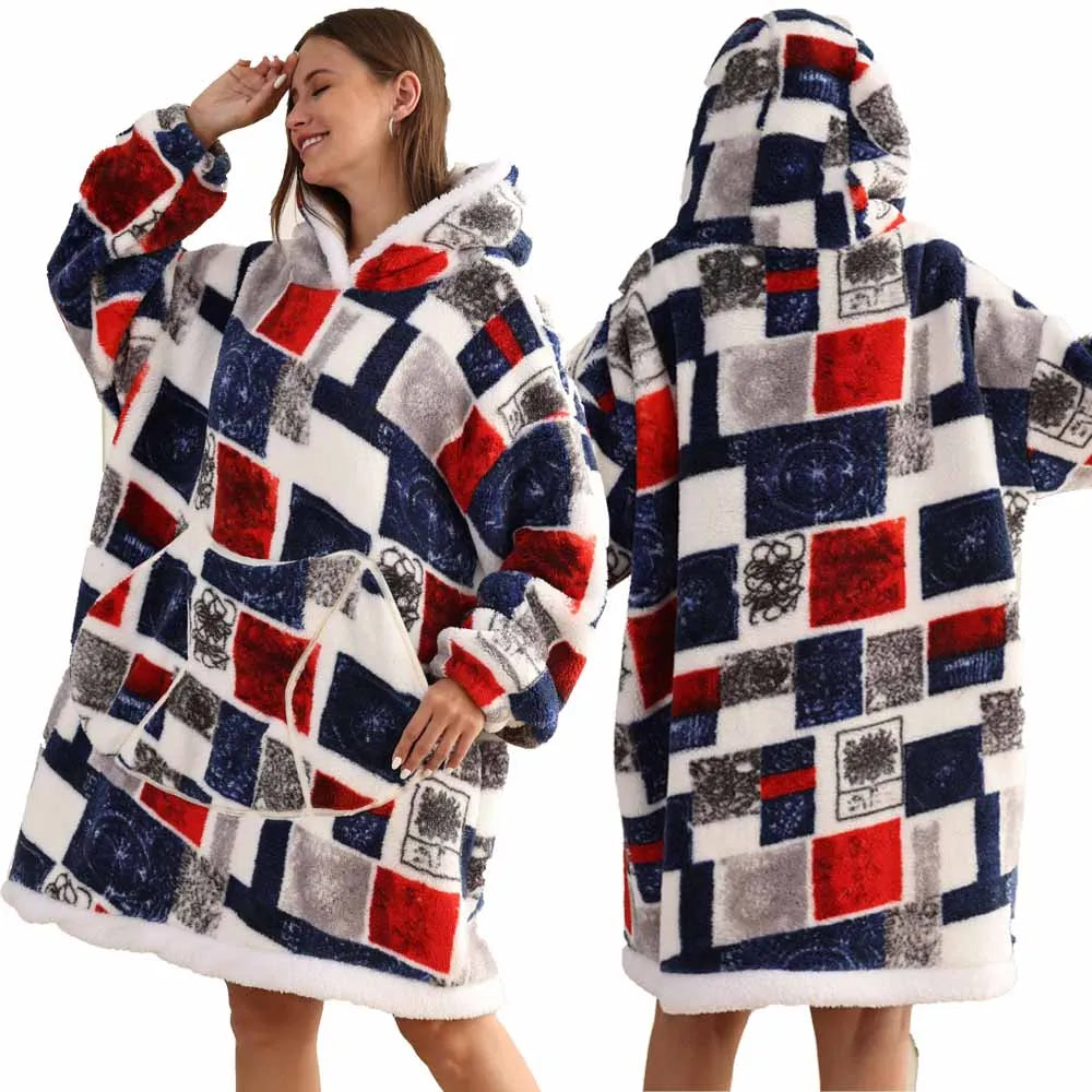 A woman models an oversized patchwork fleece hoodie featuring a mix of red, blue, and gray patterns.