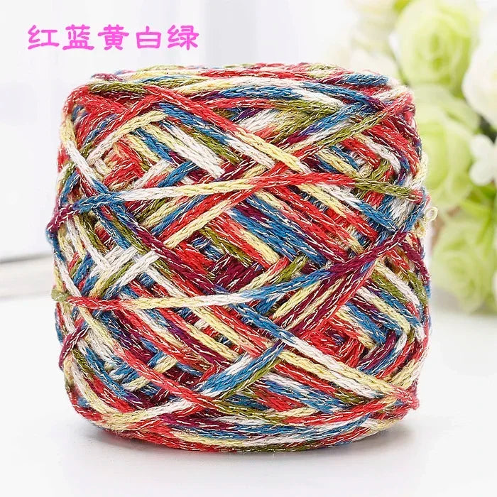 A ball of multi-colored silk yarn featuring red, blue, white, and yellow threads.