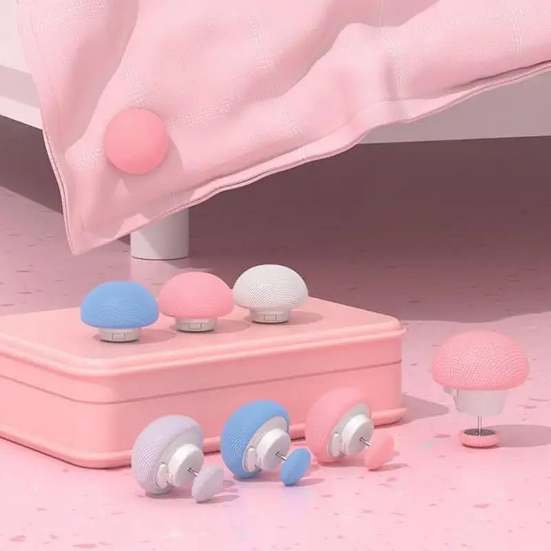 A pink duvet cover is draped with round pink clips and a set of non-slip clips in various shades of pink and blue.