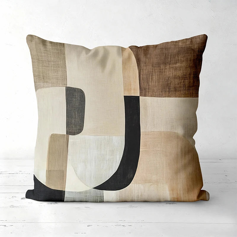 A decorative pillow cover featuring a geometric pattern of beige, brown, and gray tones.