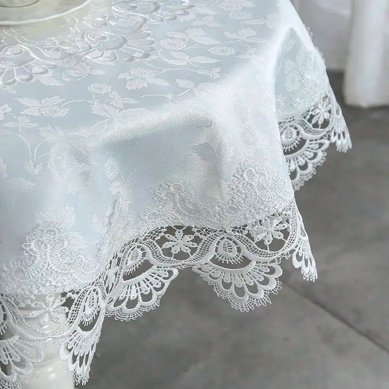 White embroidered lace tablecloth with an elegant scalloped edge