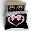 Black bedding set featuring a diamond heart print and pink bow accents.