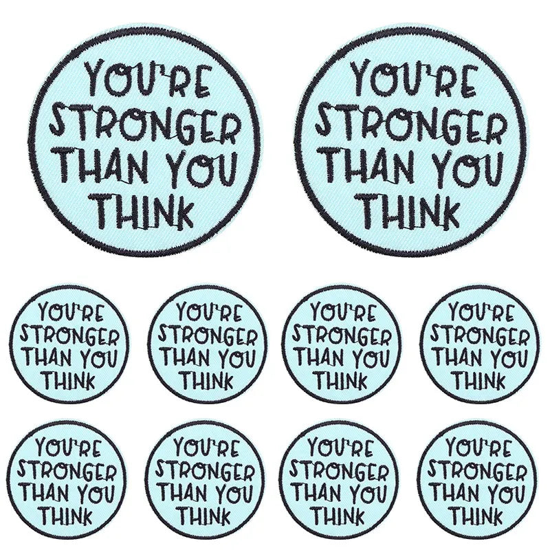 Two circular patches with embroidered text that read You're stronger than you think