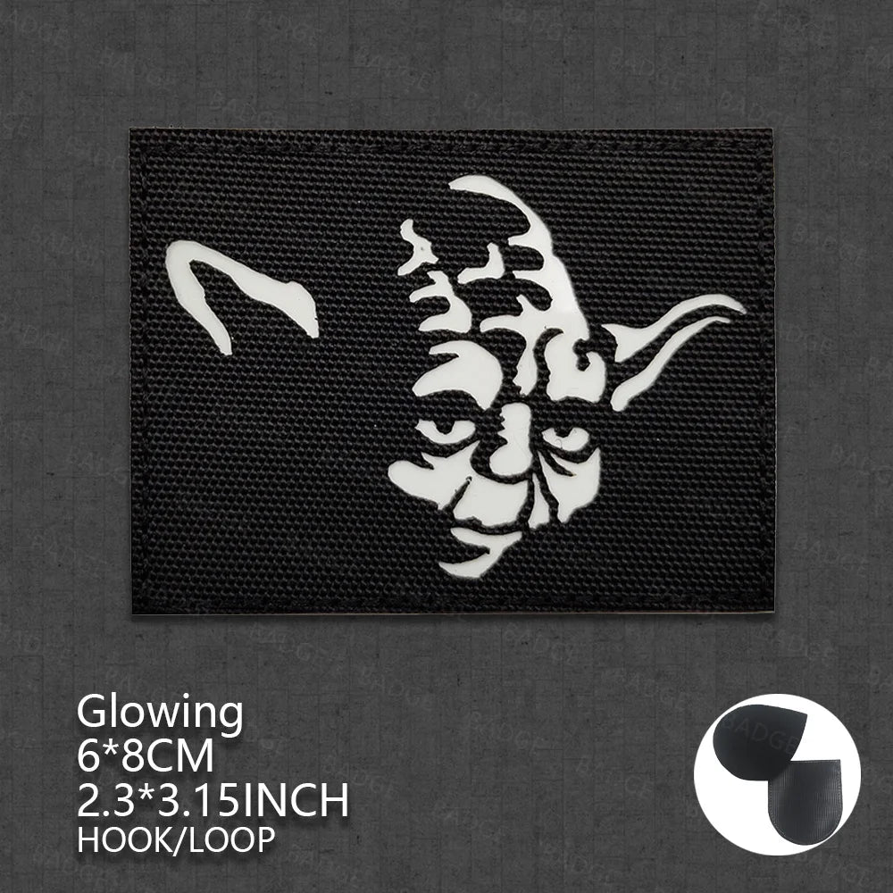 A black patch featuring a white, stylized demonic face design for tactical glow application.