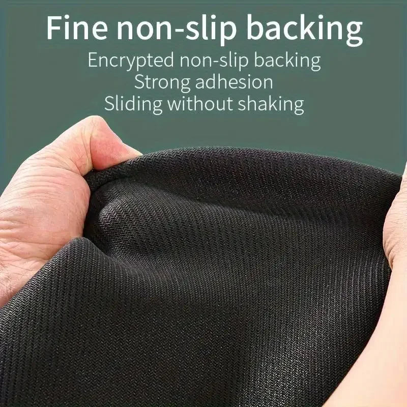 Close-up of a black non-slip backing material being held, showing strong adhesion and smooth sliding.