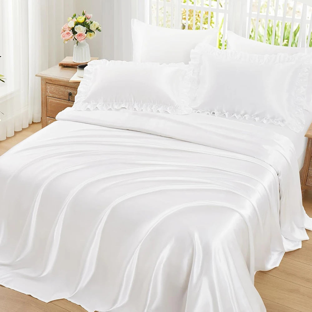 White ruffled satin pillowcase set with silky envelope closure covers on a bed