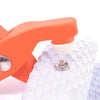 Orange pliers and a white button are shown on a gray cloth for a DIY sewing kit.