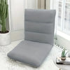A gray folding tatami seat cover placed on a white floor, next to a window and a potted cactus.