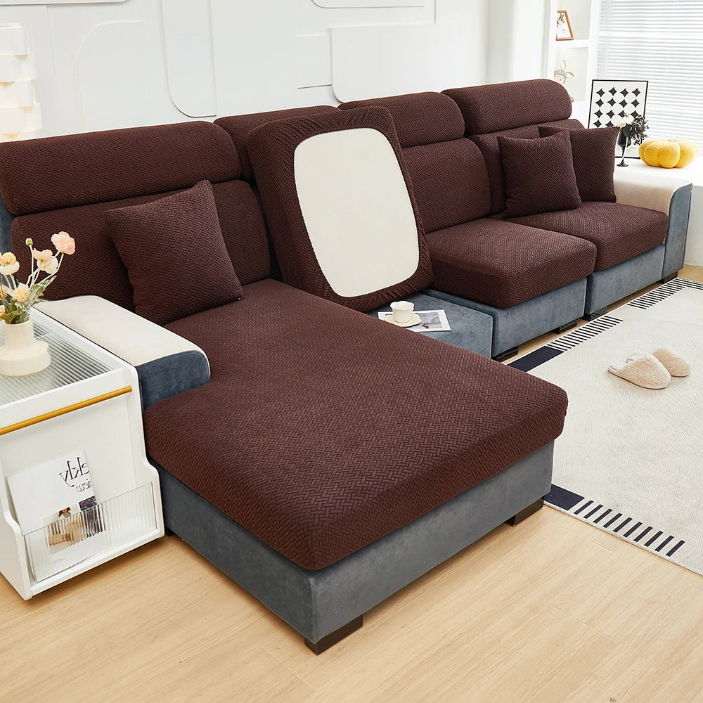 A dark brown Jacquard sofa slipcover with a white accent panel and gray base sits on a light wood floor.