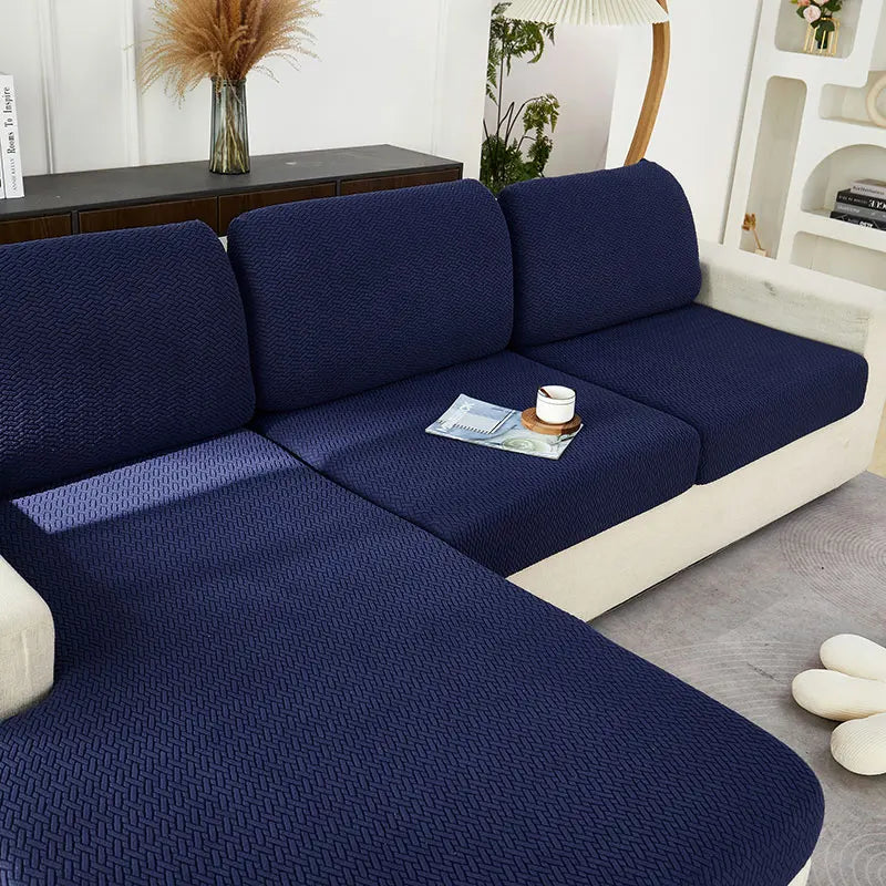 A navy blue jacquard knit sofa cushion cover featuring a textured weave and light cream trim.