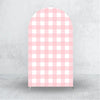 A vertical pink and white checkered fabric arch backdrop cover for events