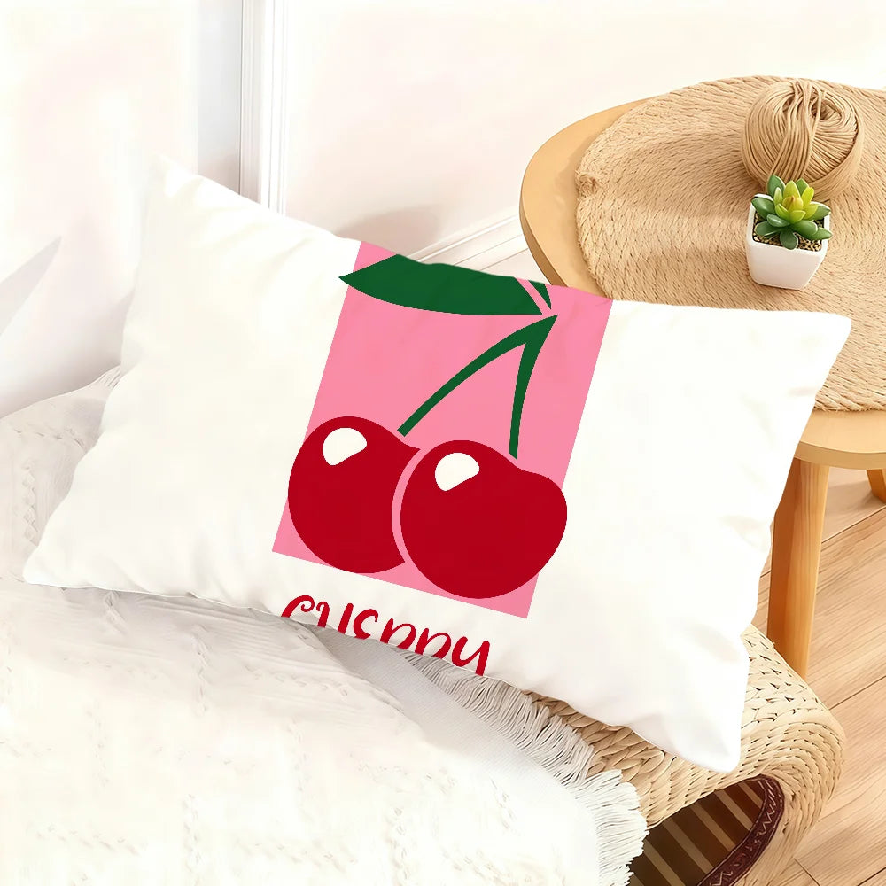 A white cushion cover featuring a pink background with a red cherry design and the word SUSY