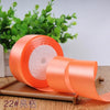 Roll of orange satin ribbon for gift wrapping and DIY crafts