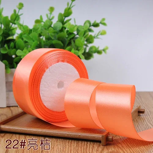 Roll of orange satin ribbon for gift wrapping and DIY crafts