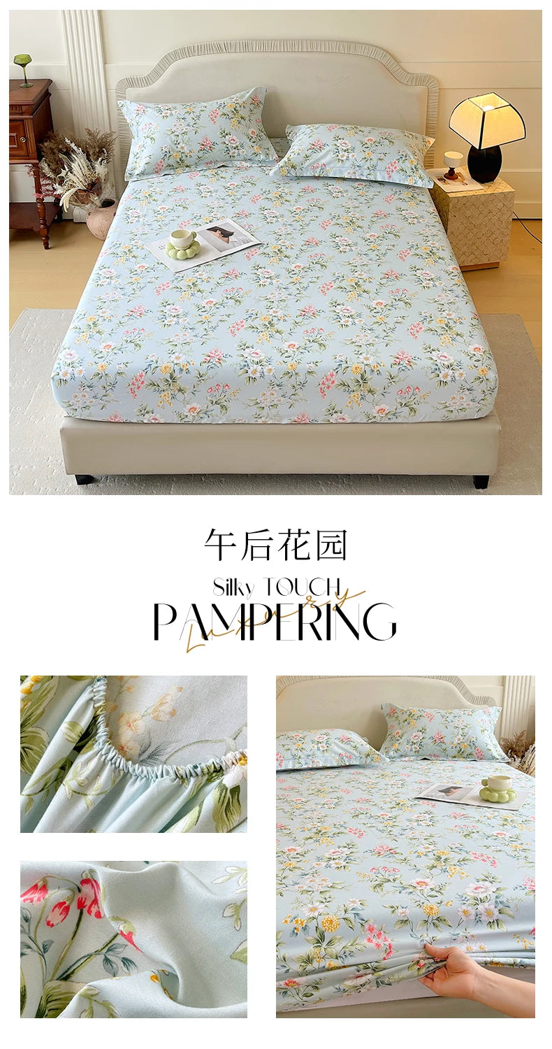 Floral printed cotton fitted sheet with delicate pink and green flowers on a bed.
