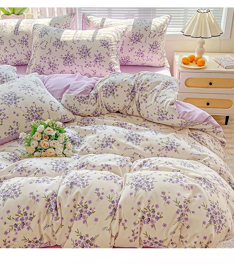 Floral printed bedding set featuring purple and cream floral patterns on a bed.