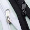 A close-up of a black zipper with a silver replacement slider and a white zipper tape.