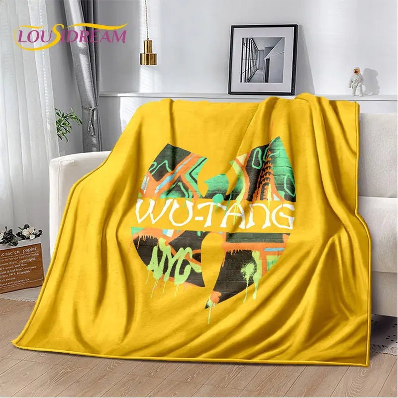 A bright yellow flannel throw blanket featuring a colorful abstract design with the word WUTANG printed on it.