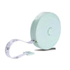 A light mint green flexible body measuring tape with a white strap and a circular plastic reel.