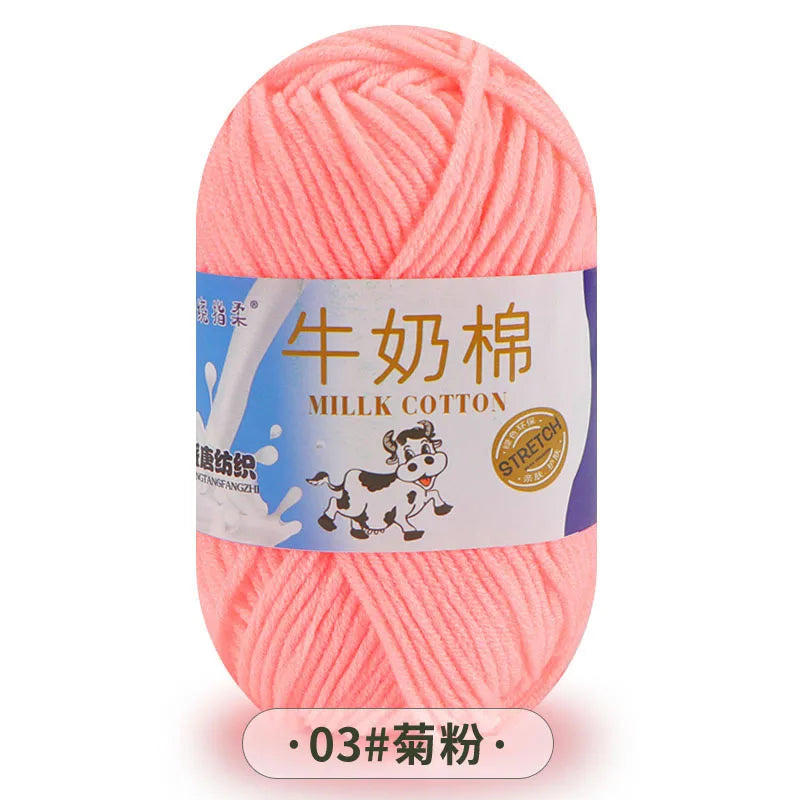 A ball of pink milk cotton yarn with Chinese text labeling.