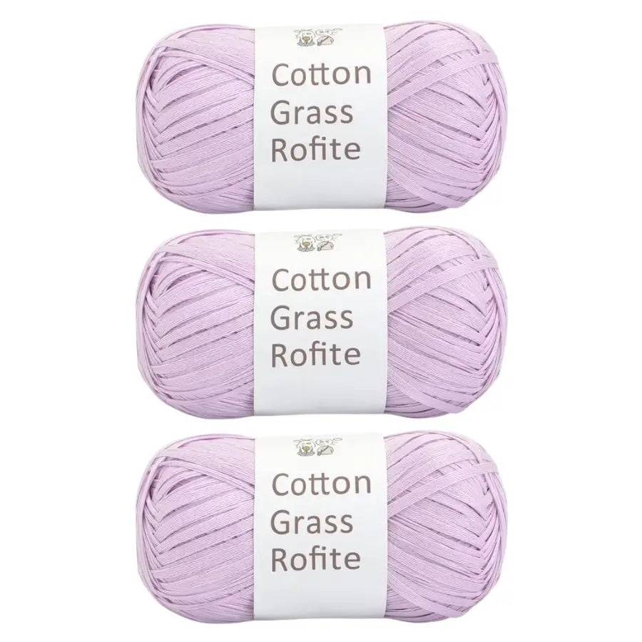 Three skeins of purple cotton grass roving yarn labeled Cotton Grass Rofite
