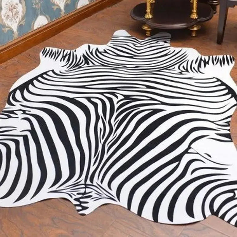 A white rug featuring a black and white zebra stripe pattern on a wooden floor.