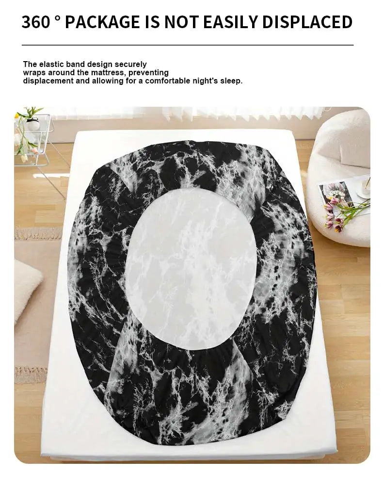 A black and white marble print fitted sheet is shown on a bed, emphasizing its secure elastic band design.