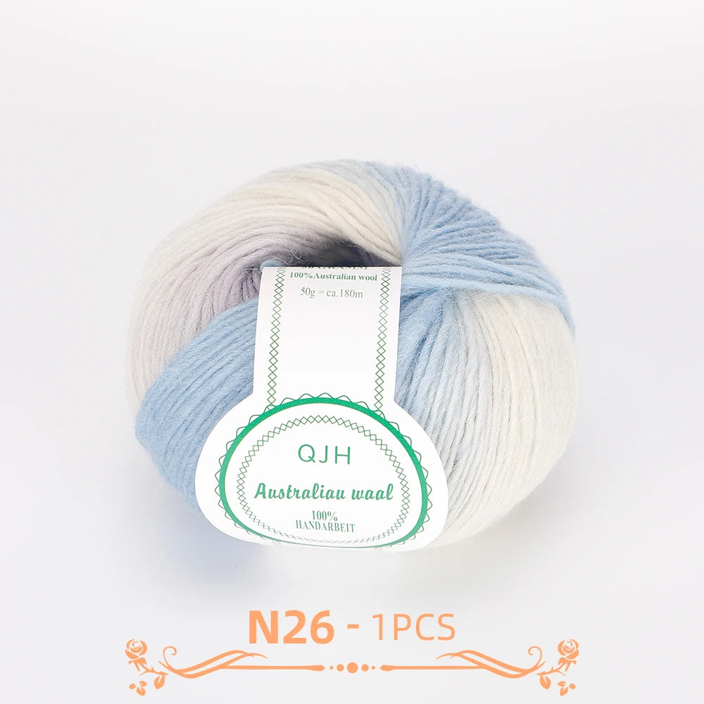 A ball of multi-colored Australian wool yarn with a label indicating QJH Australia waal handarbeit