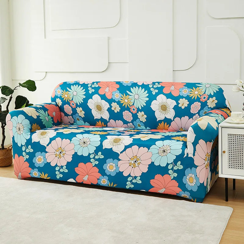 A floral patterned blue sofa slipcover displayed on a white chair and next to a white cabinet.