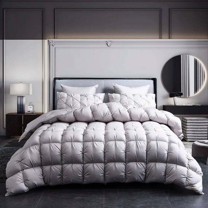 A luxury goose down duvet blanket displayed on a bed with a dark headboard and white bedding.