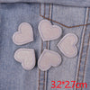 Five pink glitter heart star iron-on patches are displayed on a denim fabric background.