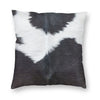 A square cushion cover featuring a black and white cowhide print faux fur design.