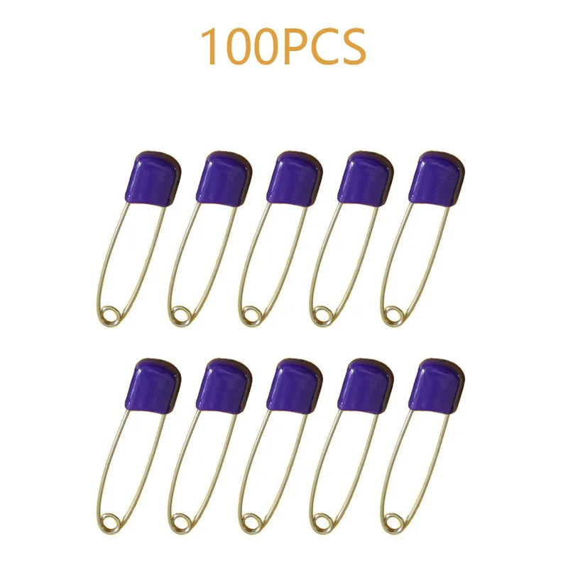 A collection of 100 stainless steel diaper pins with purple safety locking closures.
