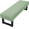 A light sage green stretch jacquard dining bench cover with a black frame.