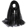 Black sheer scarf draped elegantly