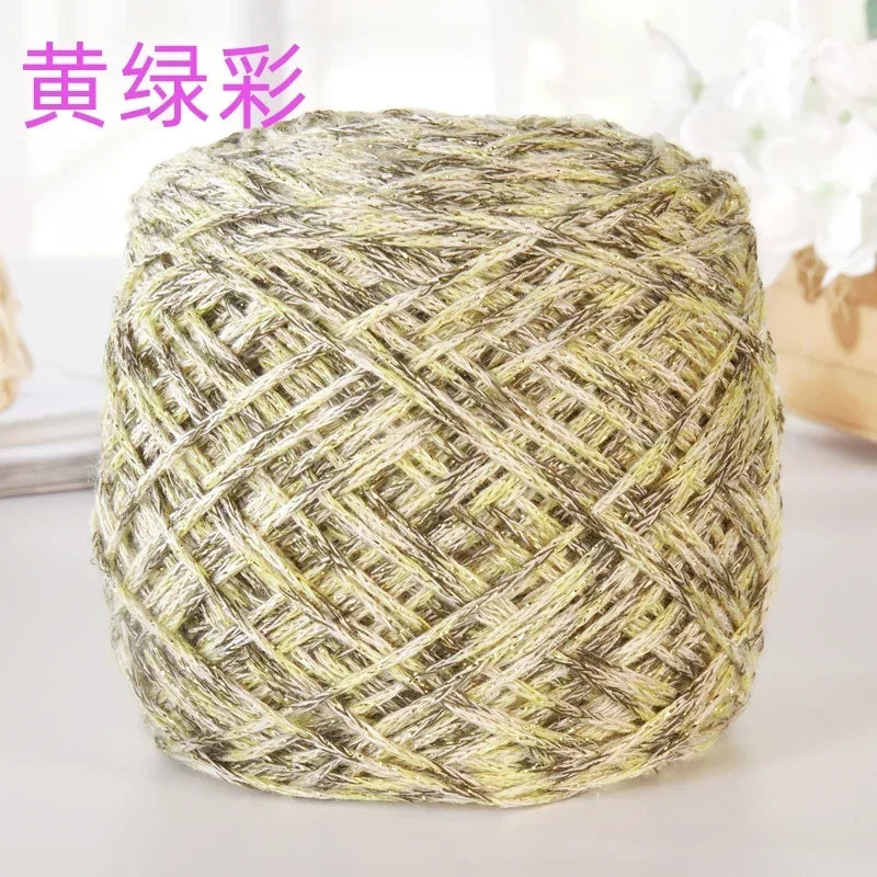 A ball of metallic silk crocheting and knitting yarn in a yellowish-green color.