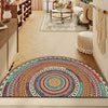 A colorful boho half-round non-slip area rug with intricate geometric patterns in earthy tones is displayed on a light wood f