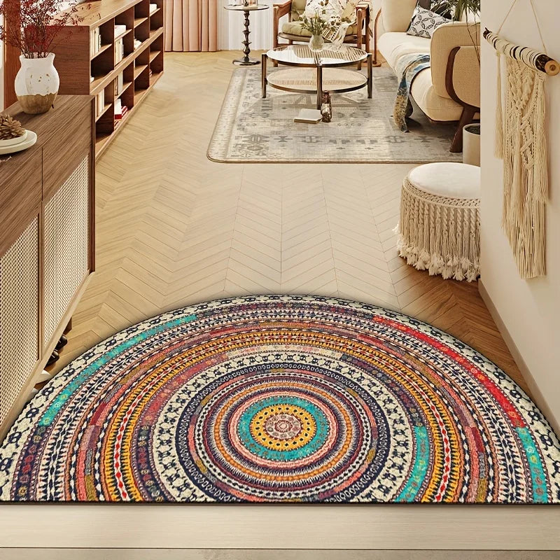 A colorful boho half-round non-slip area rug with intricate geometric patterns in earthy tones is displayed on a light wood f