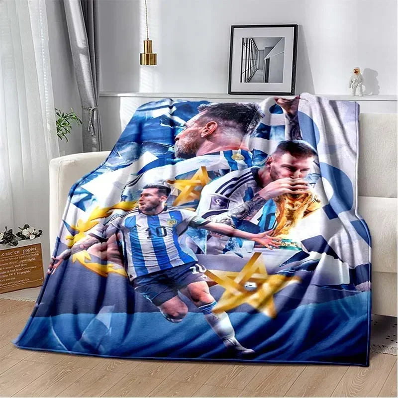 A large blanket featuring soccer players in blue and white striped jerseys against a dark blue background.