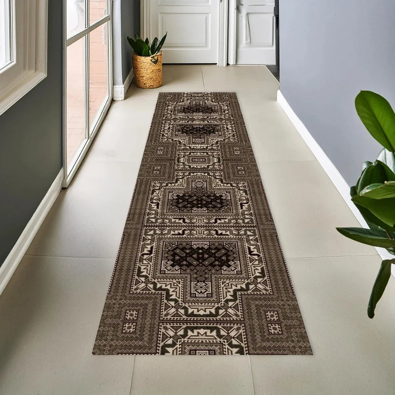 A long vintage tribal geometric runner rug in brown and beige tones placed on a light tile floor.