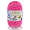 Pink milk cotton yarn skein with a label featuring a dog and stitching details
