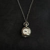 Silver pocket watch keychain with a chain and adjustable clock face against a black background