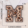 Iron-on patch of the letter M in leopard print featuring brown and black spots.