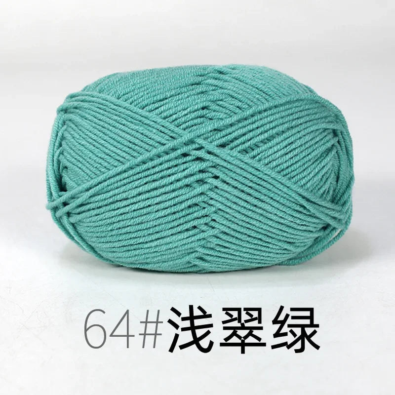 A ball of teal green knitting yarn labeled 64# 浅翠绿.