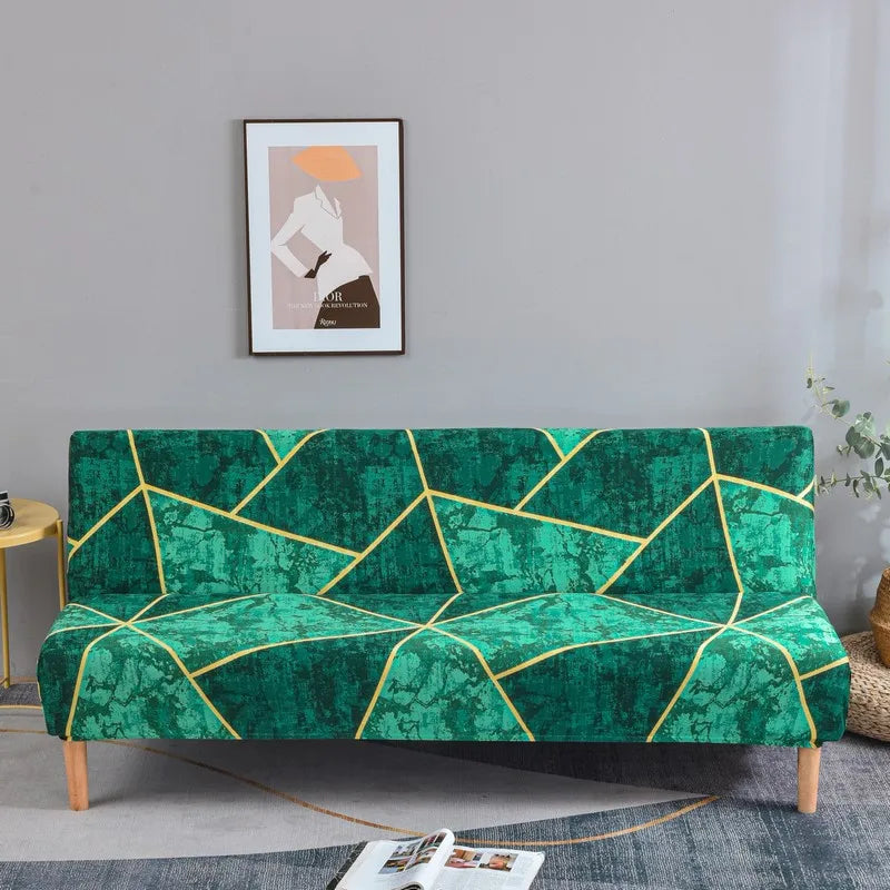 A teal geometric print spandex slipcover on a sofa bed with a gold accent, displayed in a modern living room.