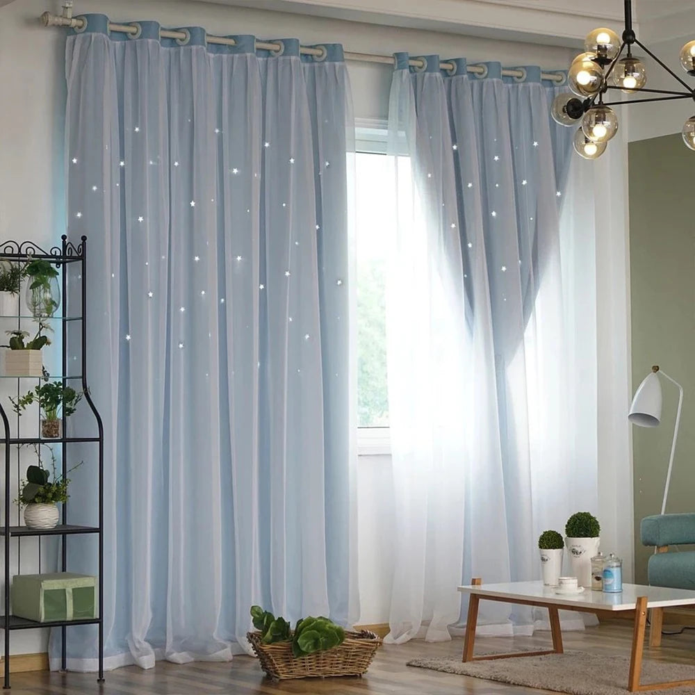 Light blue sheer curtains with a star pattern hanging in a bright room.