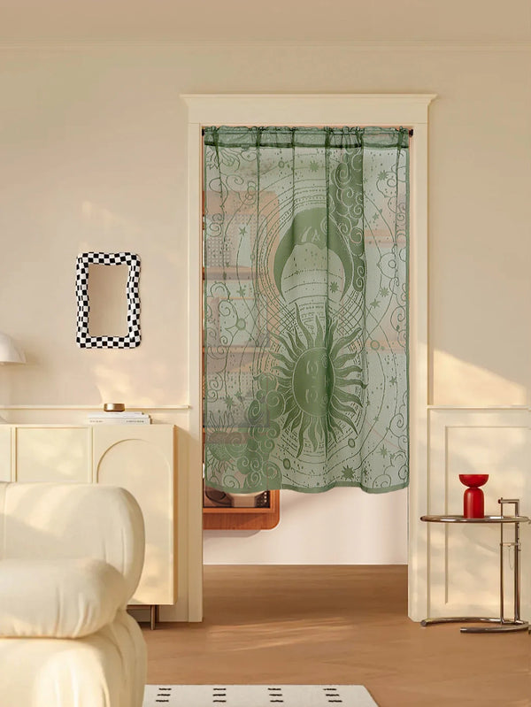 A sheer green lace door curtain with a sun and moon design hangs in a white door frame.