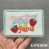 Pink embroidered patch with the text This so sweet to trust in Jesus on a light green fabric background