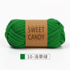 A ball of bright green sweet candy yarn labeled with Japanese text and the English words SWEET CANDY YARNS
